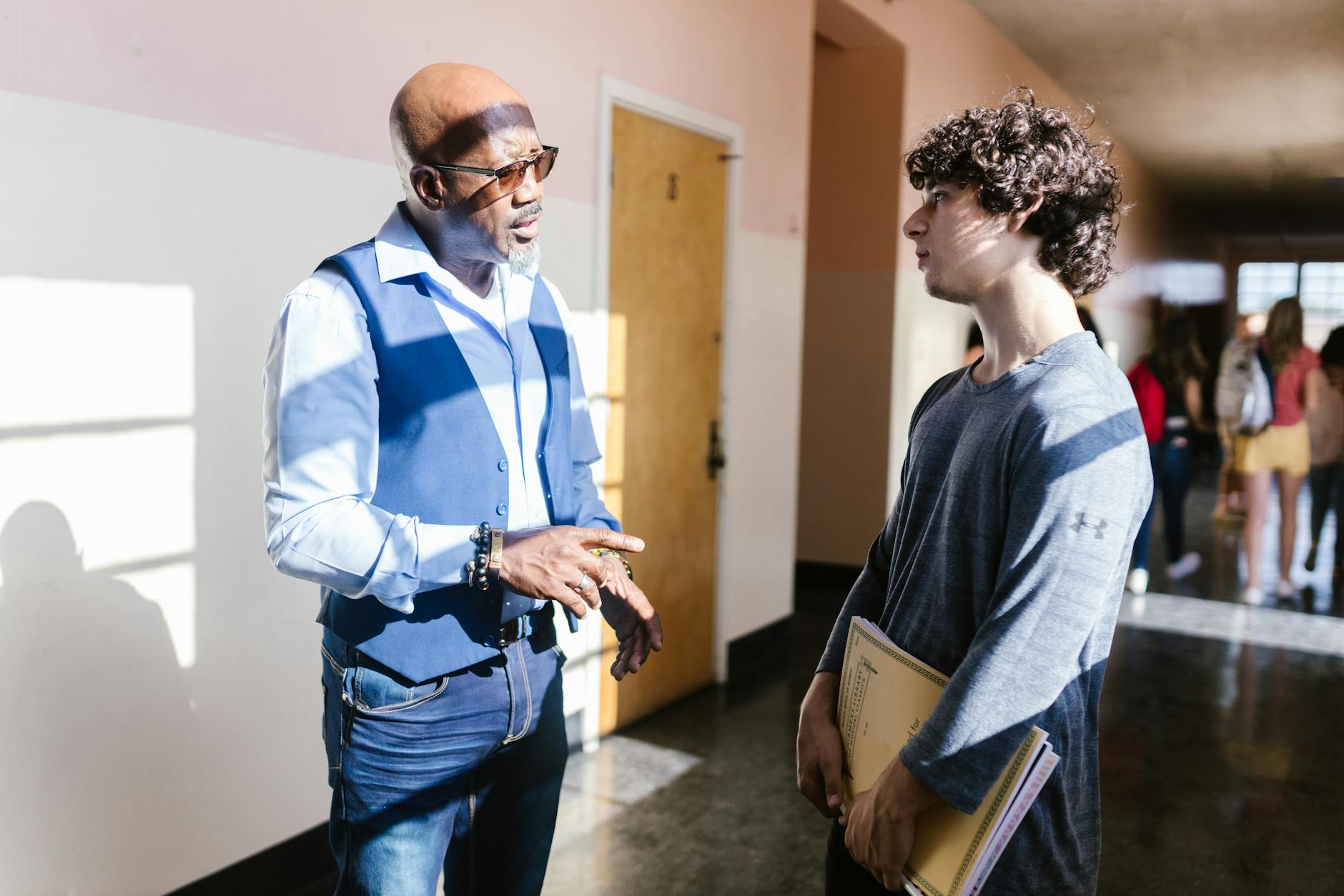 coach talking to teacher school